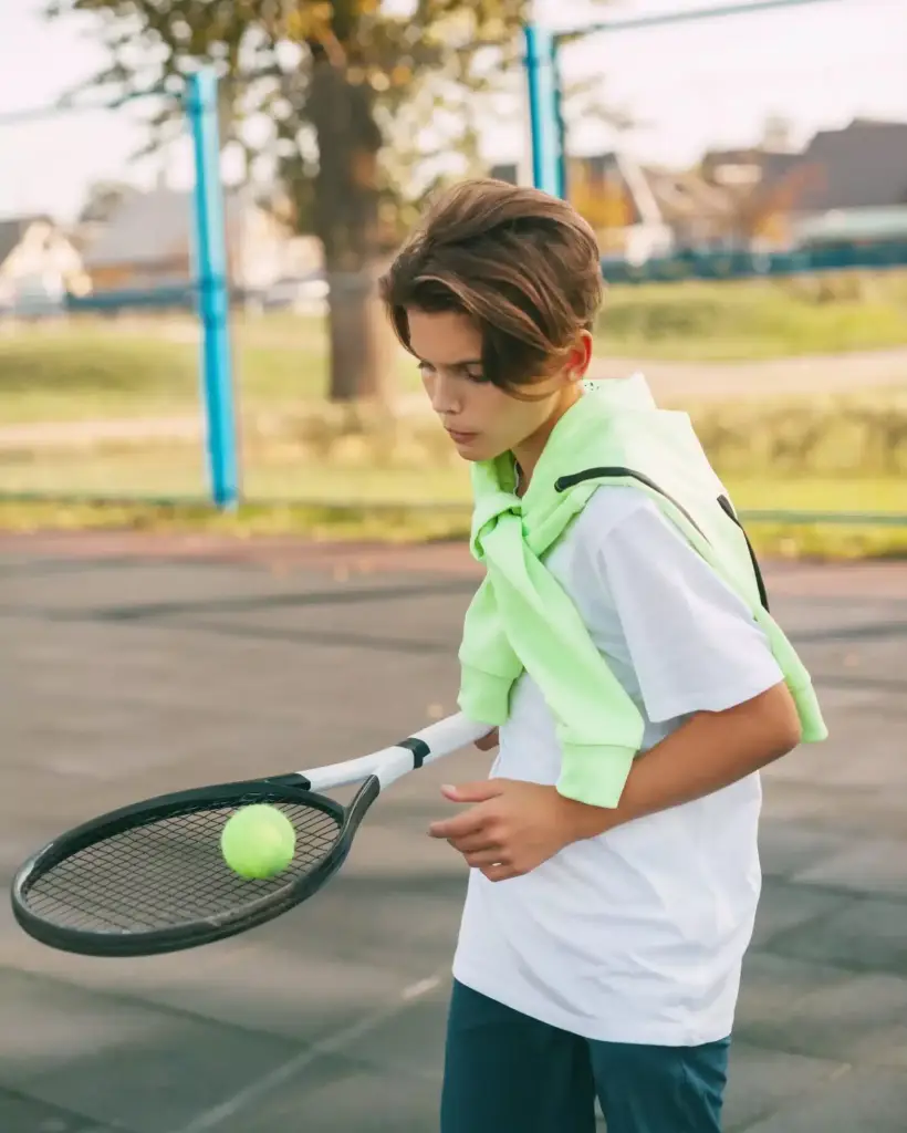 a-young-athlete-is-holding-a-tennis-racket-with-a-2022-11-15-07-05-13-utc-scaled-jpg